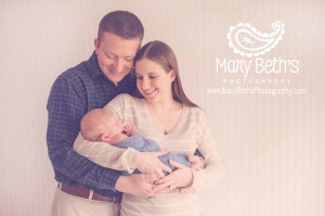 Mother and Father with newborn in a natural light studio