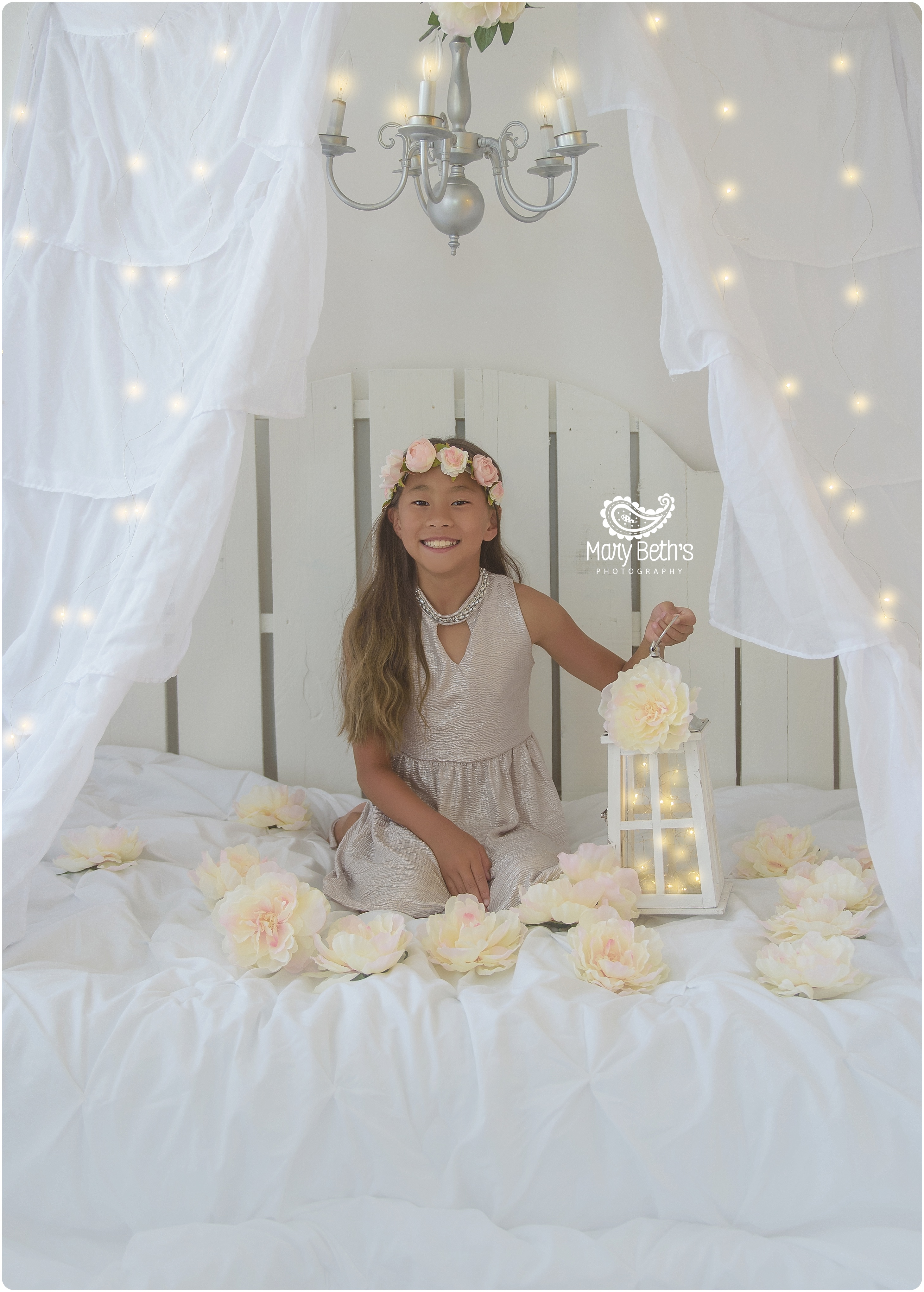 Girl in fairylight tent with lantern and hanging tulips