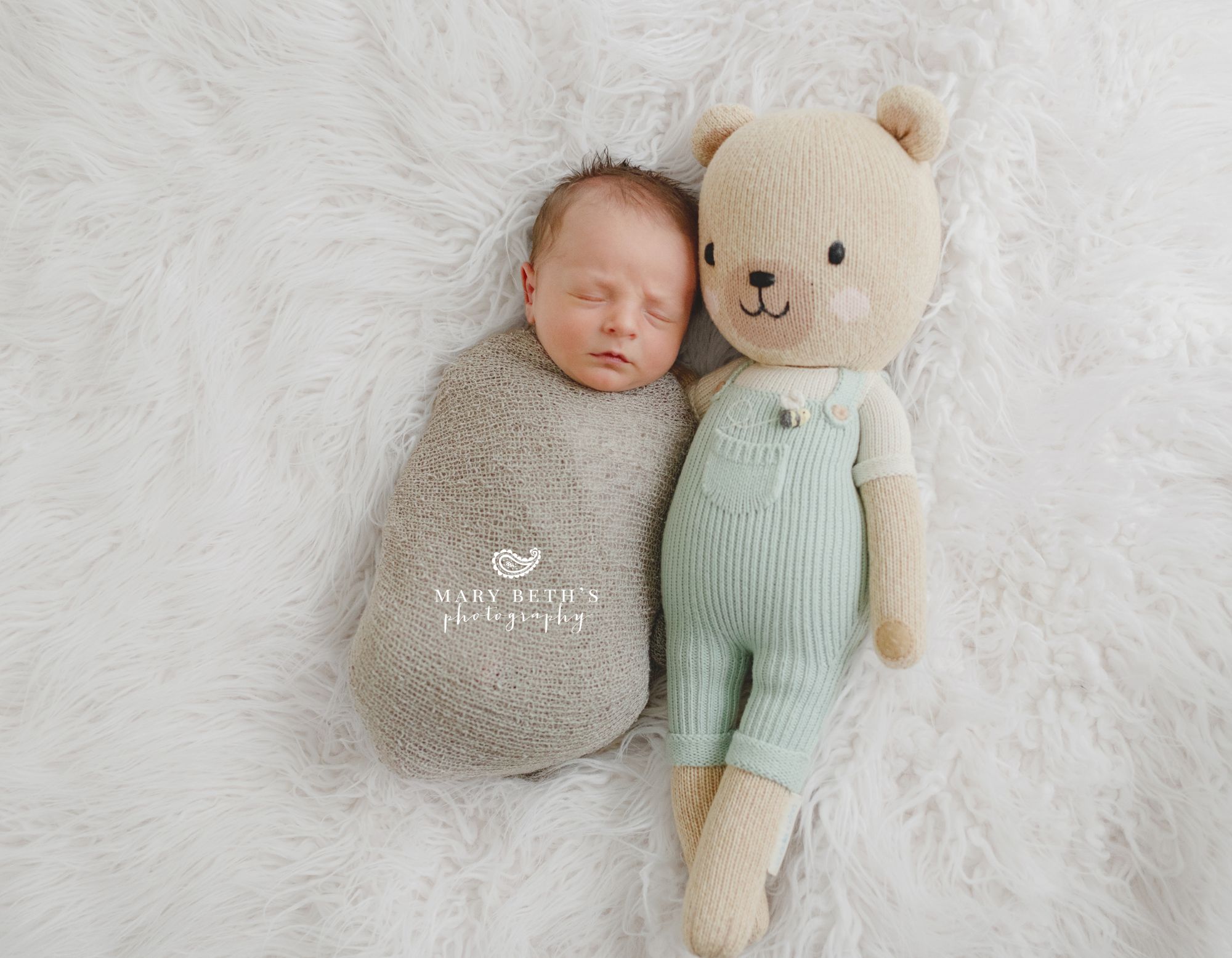 newborn baby boy with stuffed animal