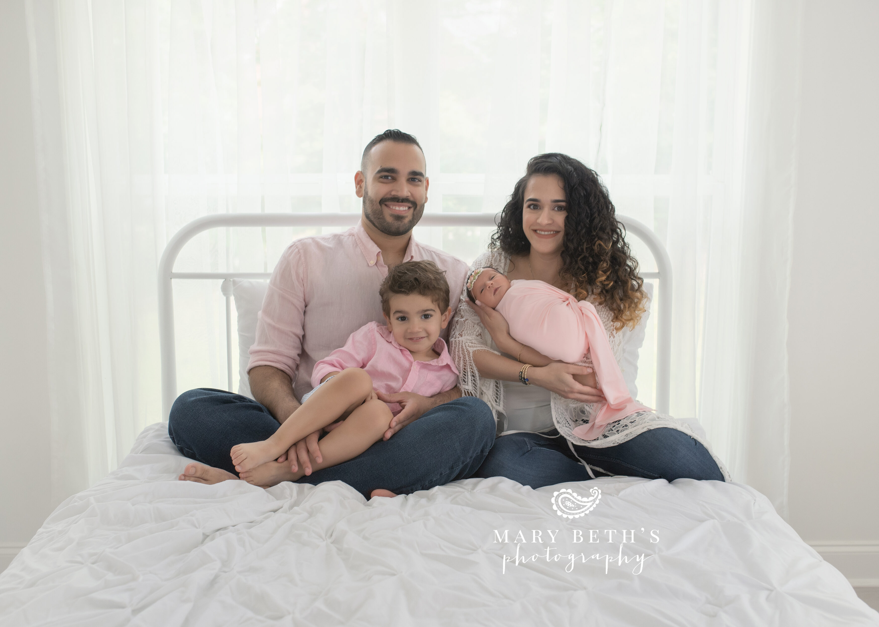 studio family newborn portraits on a bed in augusta, ga