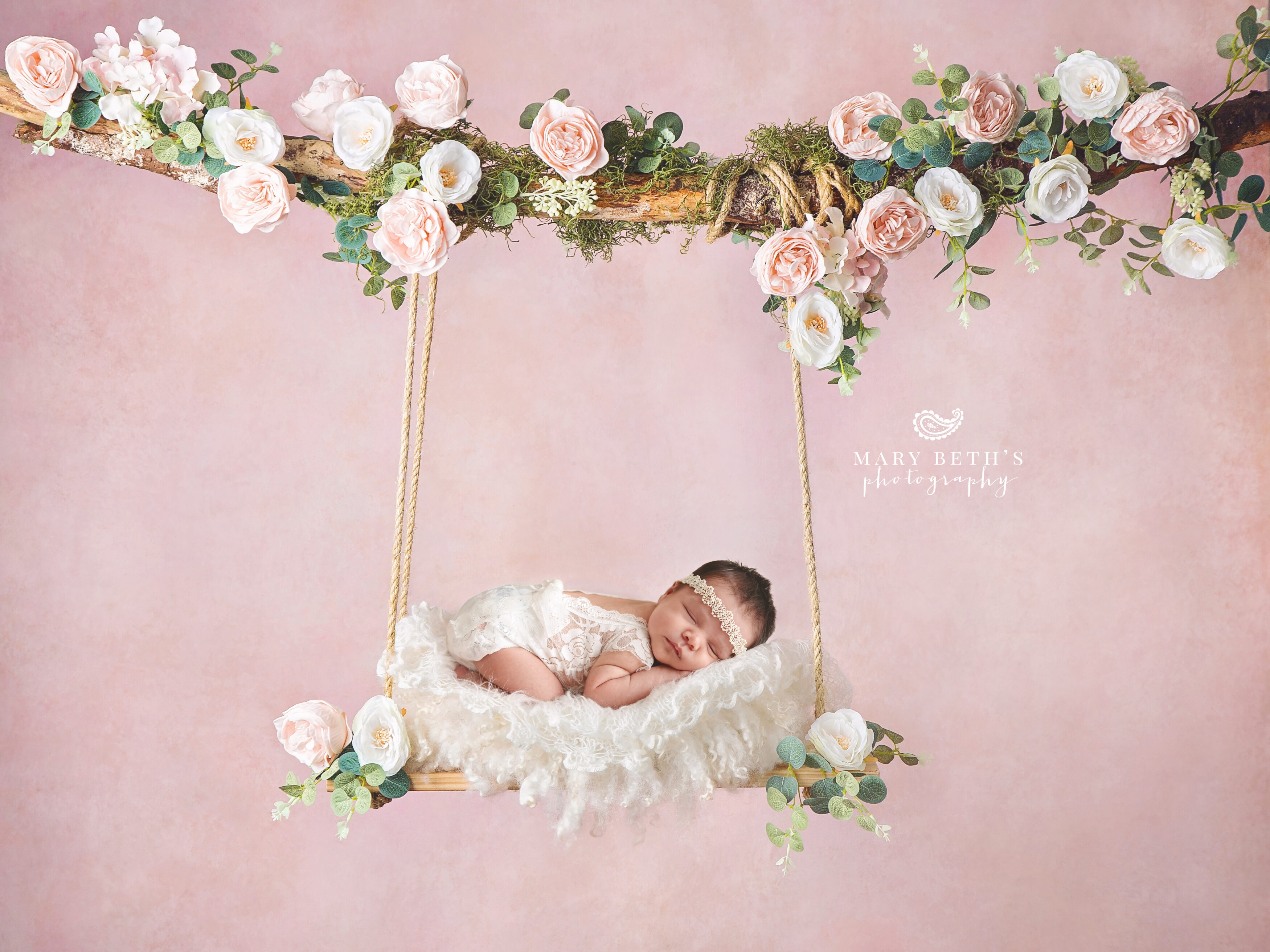 newborn girl on floral swing.